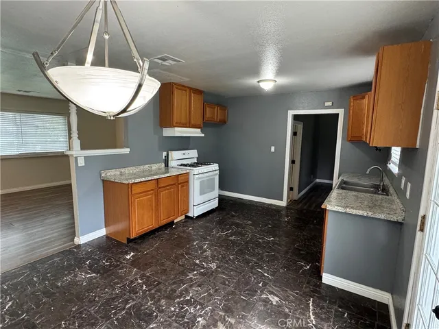 a room with a sink wooden floor and a mirror