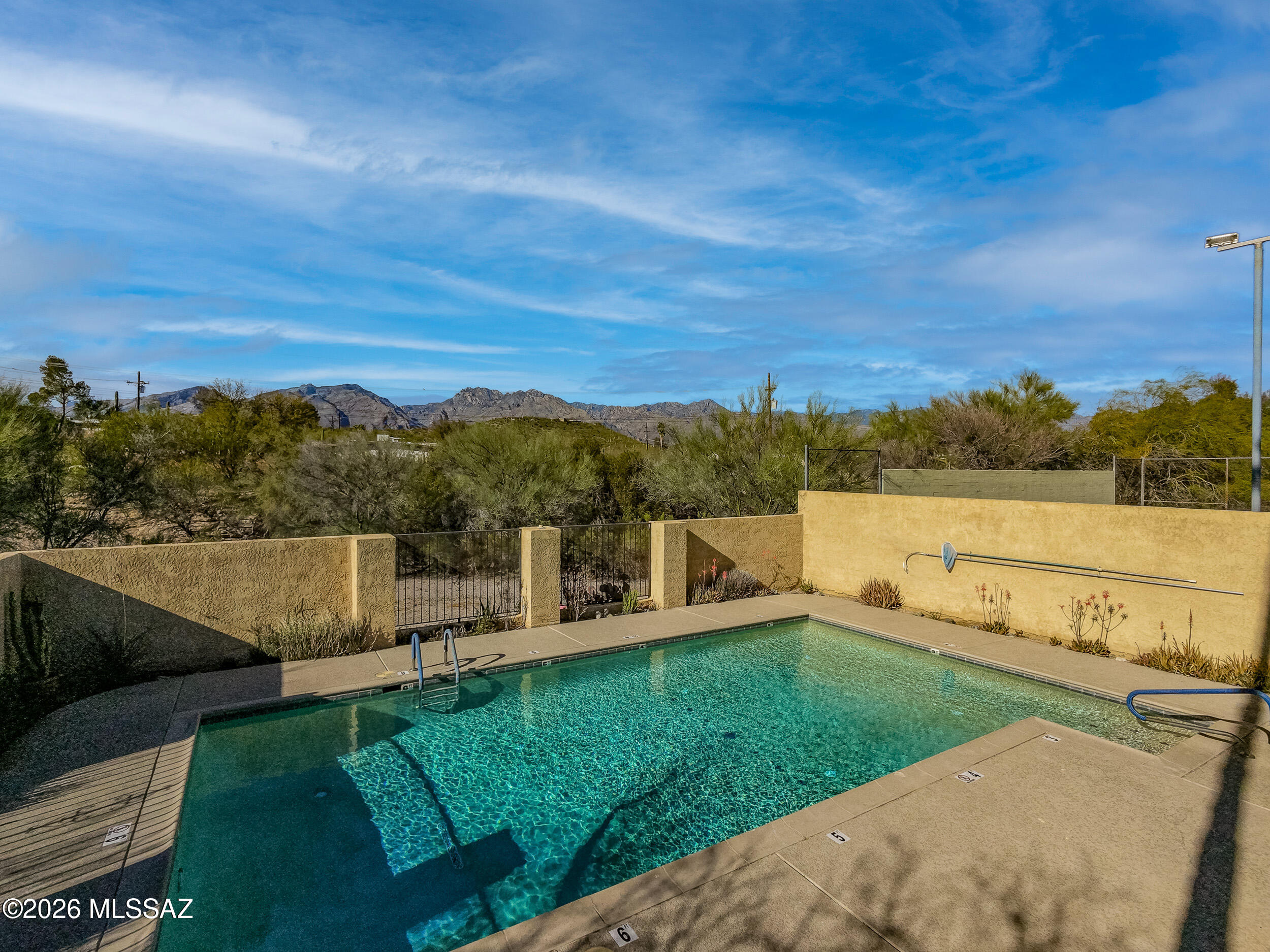 6941 East Rivercrest Road Tucson, AZ 85750 - Photo 26 of 32 a view of a lake with houses in the back
