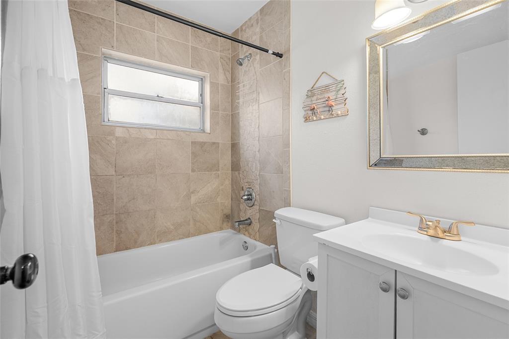 4939 100th Way North St. Petersburg, FL 33708 - Photo 27 of 43 a bathroom with a sink a toilet and shower