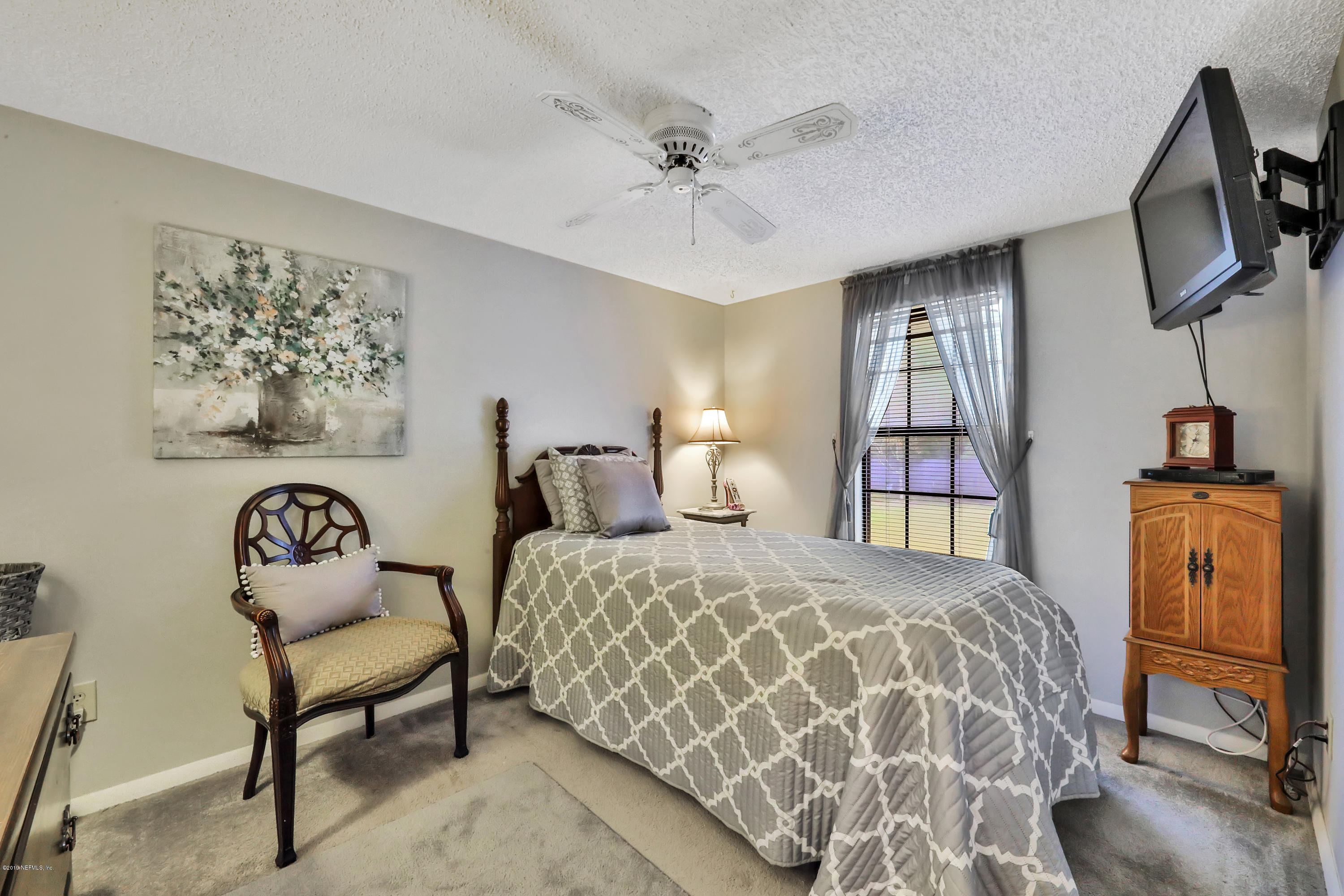 3700 Joe Ashton Road St. Augustine, FL 32092 - Photo 29 of 52 a bedroom with a bed and a chandelier