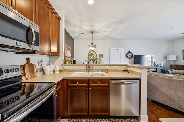 a kitchen with a sink stove and microwave