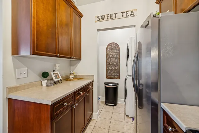 a kitchen with stainless steel appliances granite countertop a refrigerator a sink and a stove