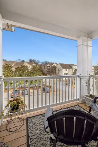 a view of a balcony with chair and wooden floor