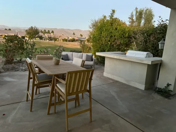 a view of a terrace with furniture and city view