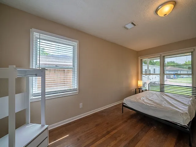 a bedroom with furniture and a window
