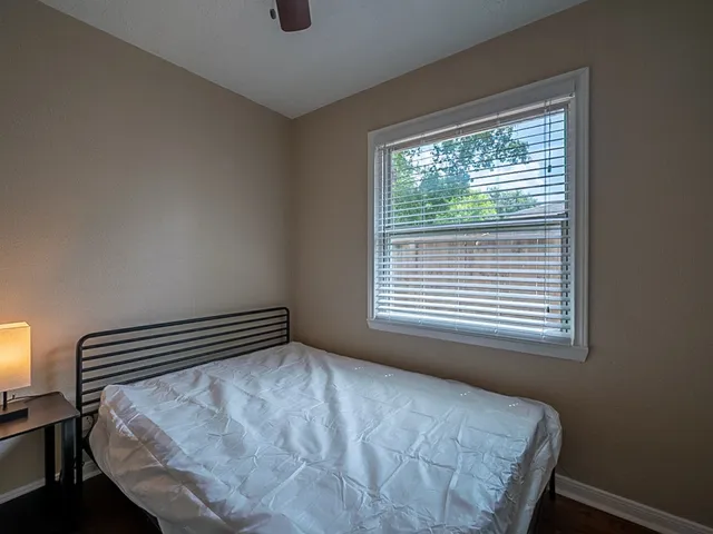 a bedroom with a bed and a window