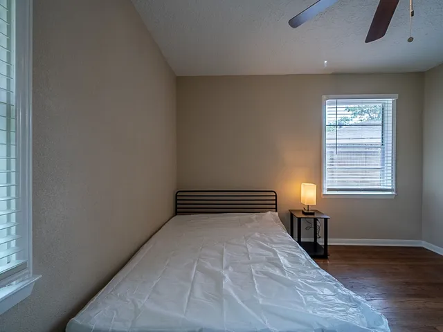 a view of a room with wooden floor and windows