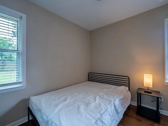 a bedroom with a bed and window