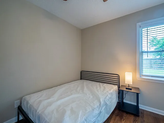 a bedroom with a bed and a window