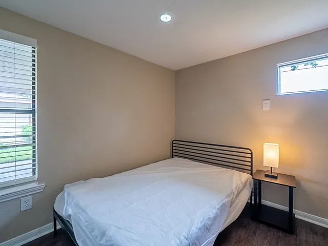 a bedroom with a bed and a window