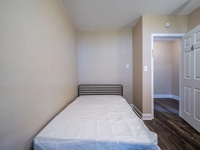 a view of a room with wooden floor and staircase