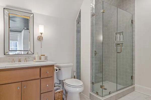 a bathroom with a granite countertop sink toilet and shower