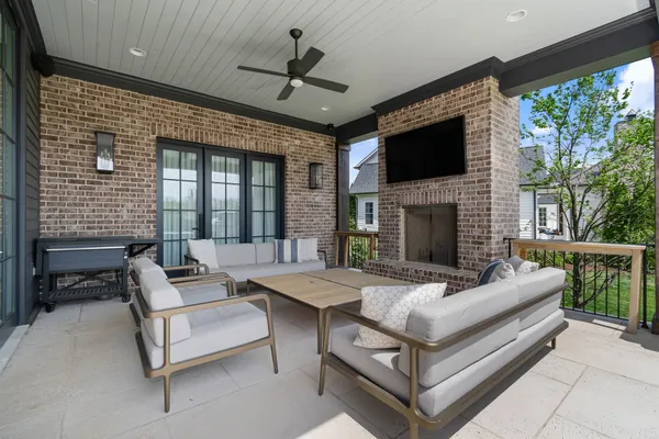 a view of a house with backyard and sitting area