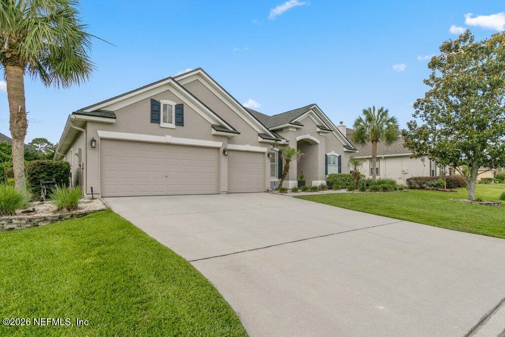 841 Ifield Road St. Augustine, FL 32095 - Photo 2 of 69 a front view of a house with a yard and garage