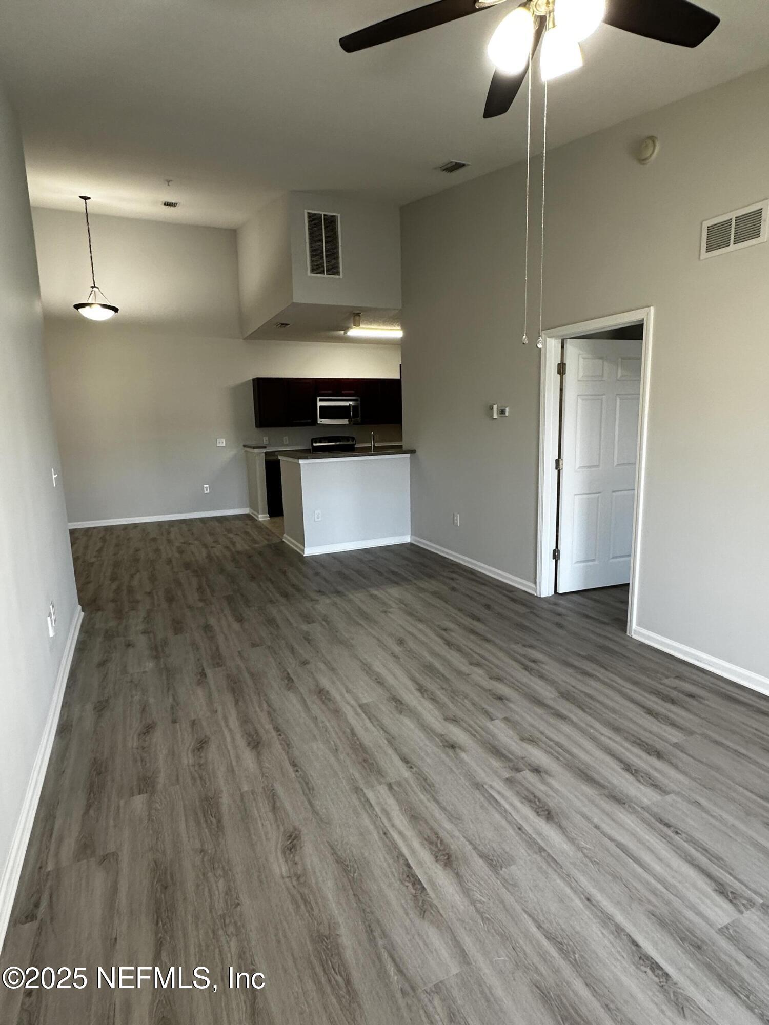 4917 Key Lime Drive, Unit 306 Jacksonville, FL 32256 - Photo 12 of 51 a view of empty room with wooden floor