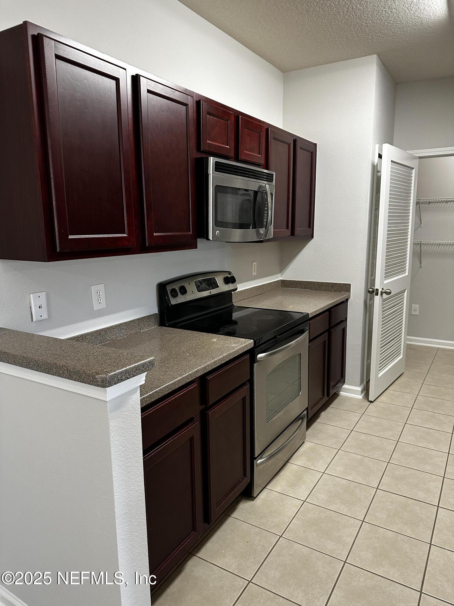4917 Key Lime Drive, Unit 306 Jacksonville, FL 32256 - Photo 15 of 51 a kitchen with a sink and a microwave