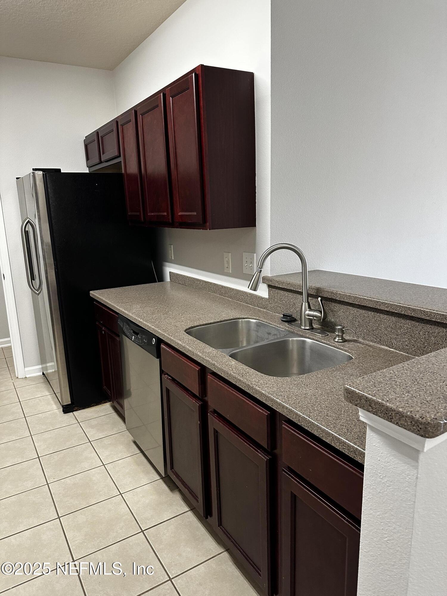 4917 Key Lime Drive, Unit 306 Jacksonville, FL 32256 - Photo 16 of 51 a kitchen with a sink and a refrigerator