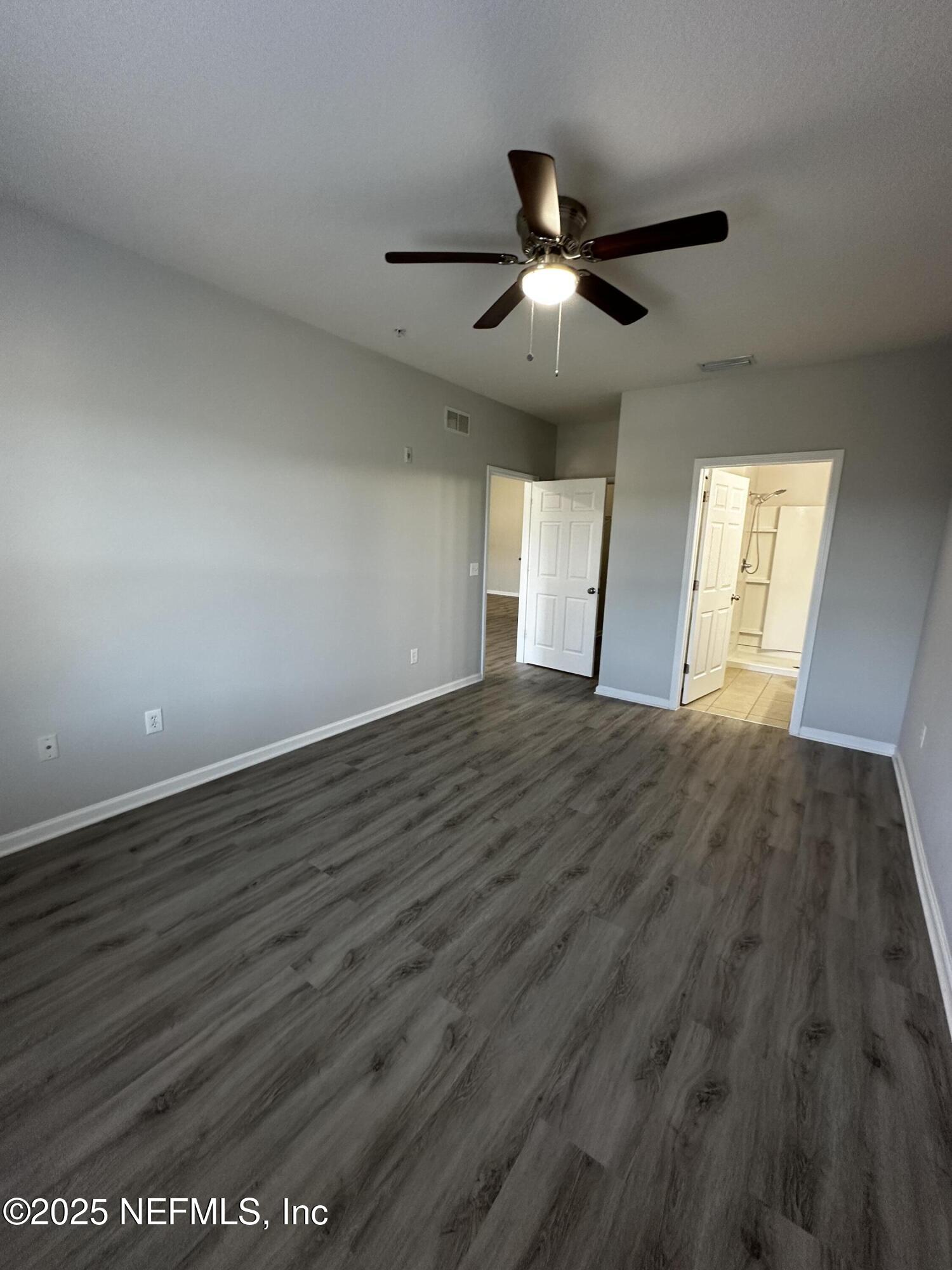 4917 Key Lime Drive, Unit 306 Jacksonville, FL 32256 - Photo 22 of 51 wooden floor in an empty room with a window