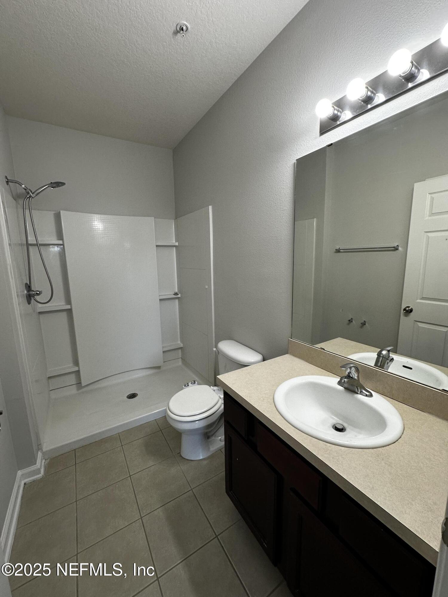 4917 Key Lime Drive, Unit 306 Jacksonville, FL 32256 - Photo 23 of 51 a bathroom with a sink a toilet and shower