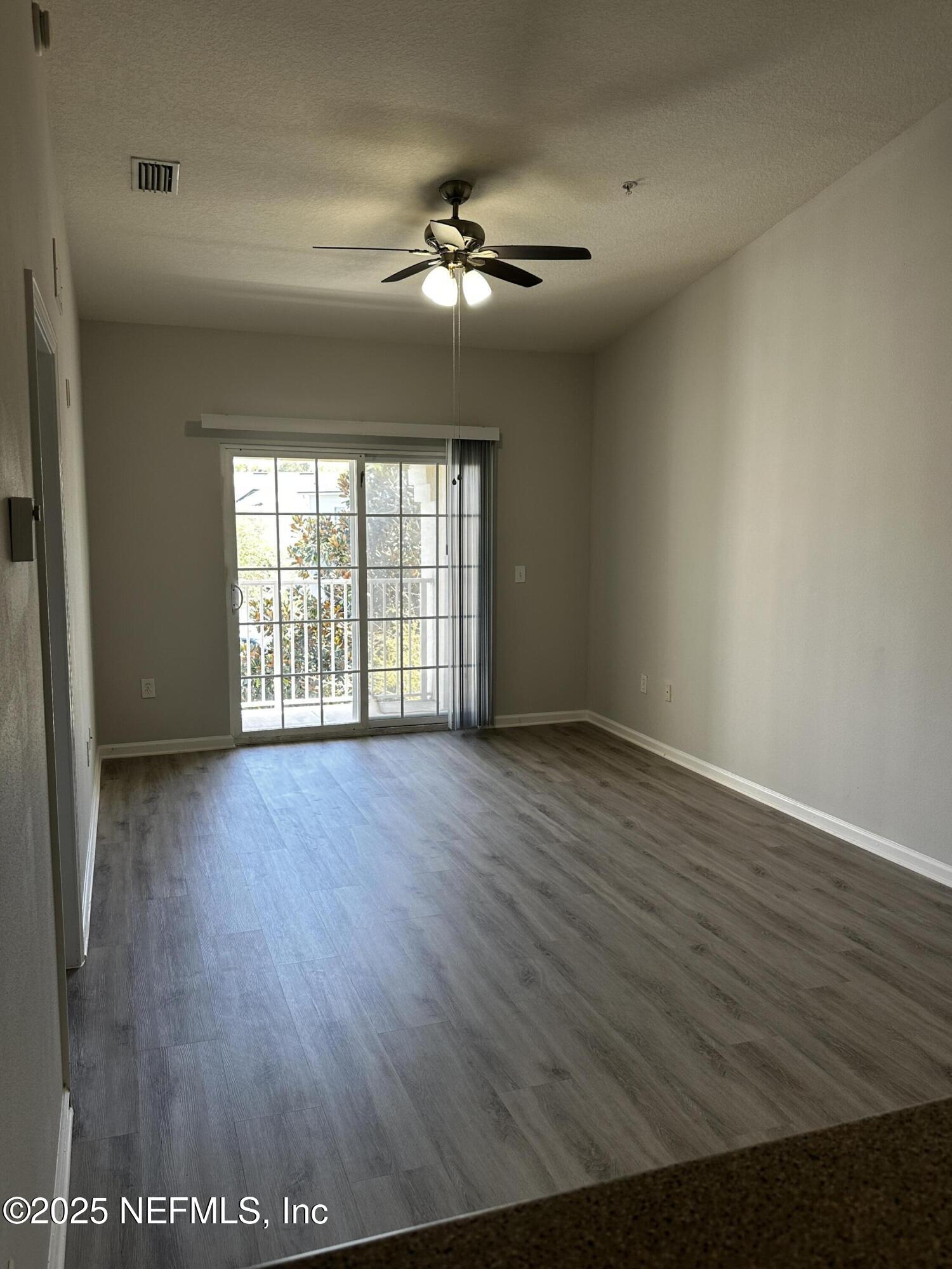 4917 Key Lime Drive, Unit 306 Jacksonville, FL 32256 - Photo 6 of 51 wooden floor in an empty room with a window