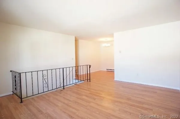 a view of a room with wooden floor