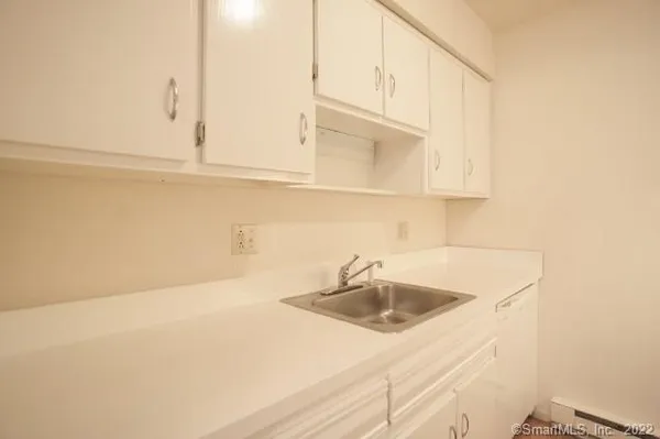 a bathroom with a sink and cabinets