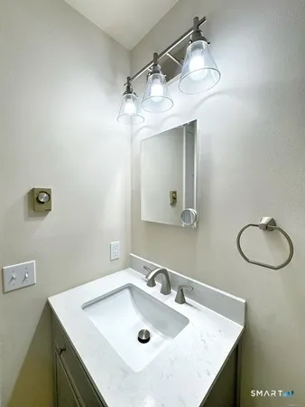 a bathroom with a sink vanity and a mirror