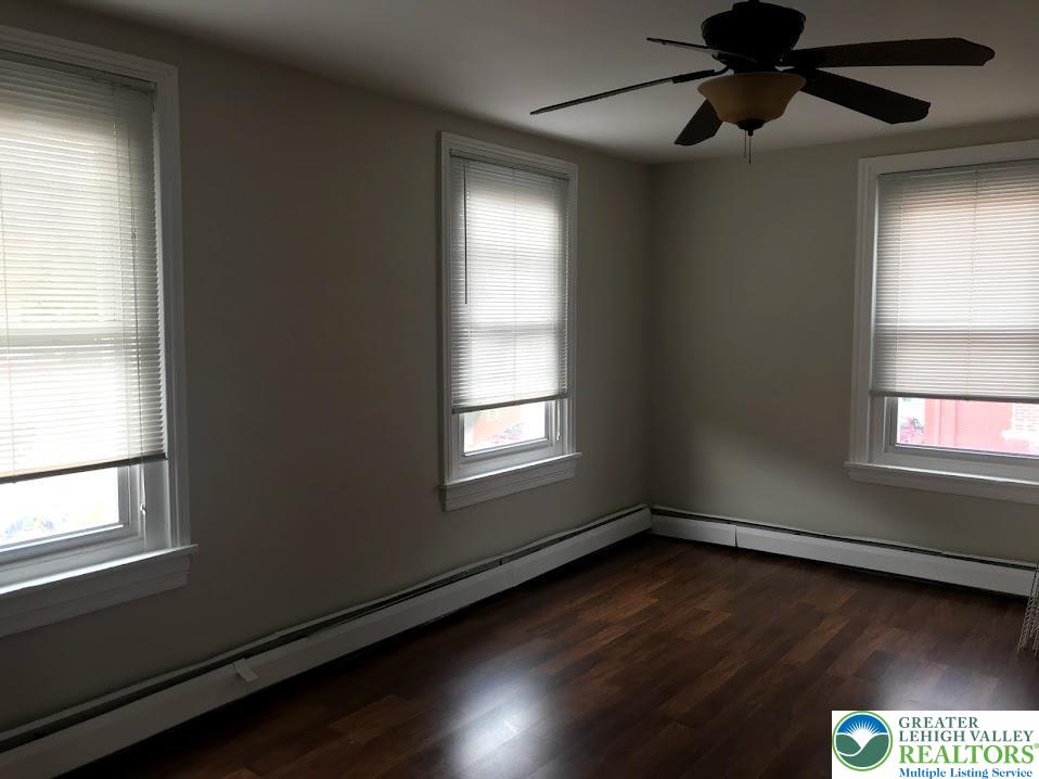 601 Pawnee Street Bethlehem, PA 18015 - Photo 2 of 6 a view of an empty room with wooden floor and a window