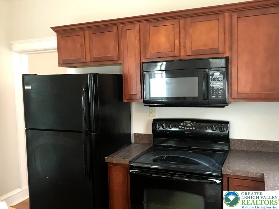 601 Pawnee Street Bethlehem, PA 18015 - Photo 5 of 6 a kitchen with a stove microwave and refrigerator