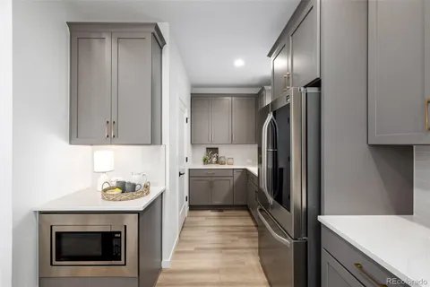 a kitchen with cabinets and stainless steel appliances