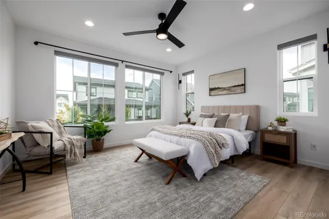 a spacious bedroom with a bed and large windows