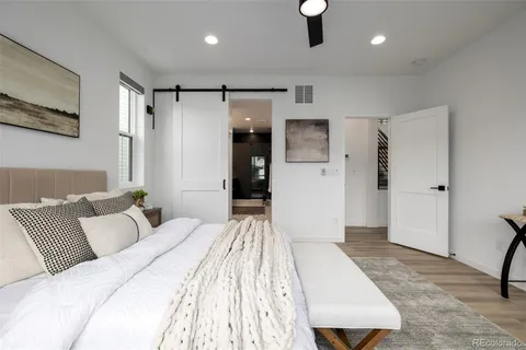 a bedroom with a large bed and a couch