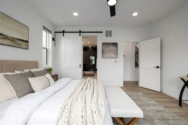 a bedroom with a large bed and a couch