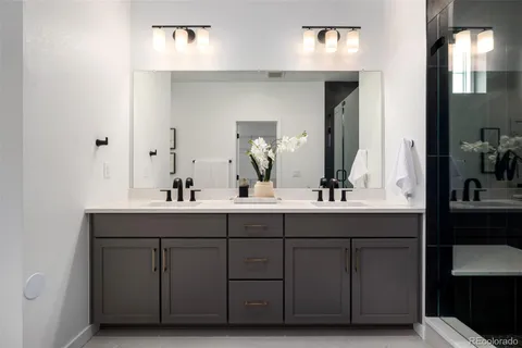 a bathroom with a double vanity sink and a mirror