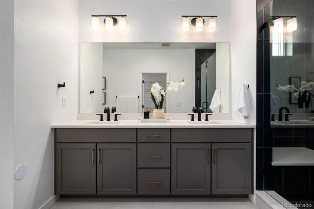 a bathroom with a double vanity sink and a mirror