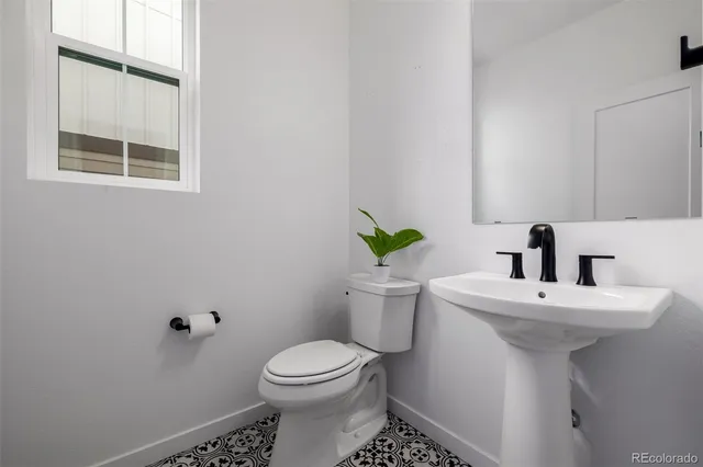 a bathroom with a sink toilet and a mirror