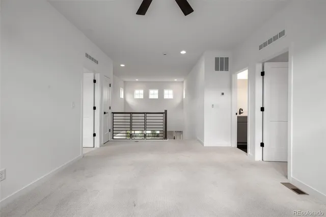 an empty room with closet and windows