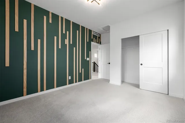 a view of a hallway with wooden staircase