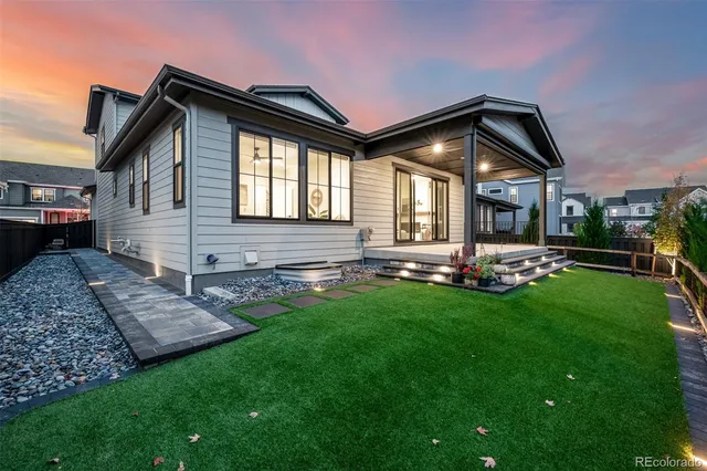 a front view of a house with swimming pool having outdoor seating