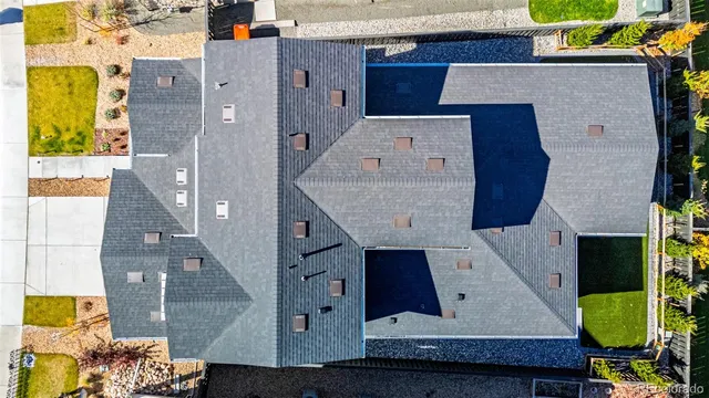 an aerial view of a house with a swimming pool