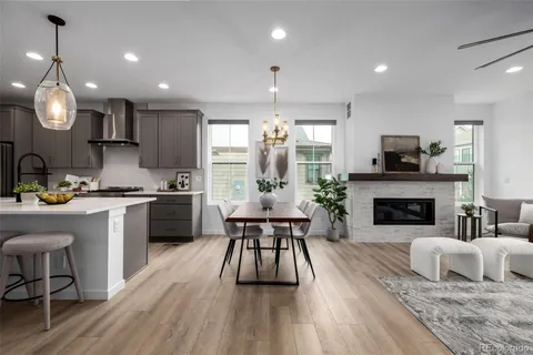 a kitchen with sink a microwave a stove and chairs