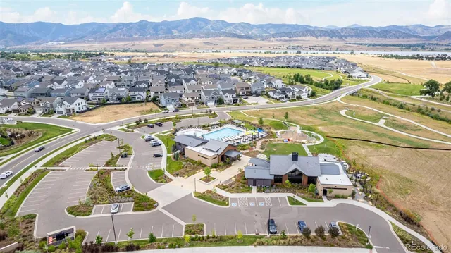 a view of a swimming pool with a table chairs