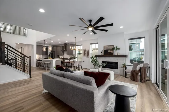 a living room with fireplace furniture and a wooden floor