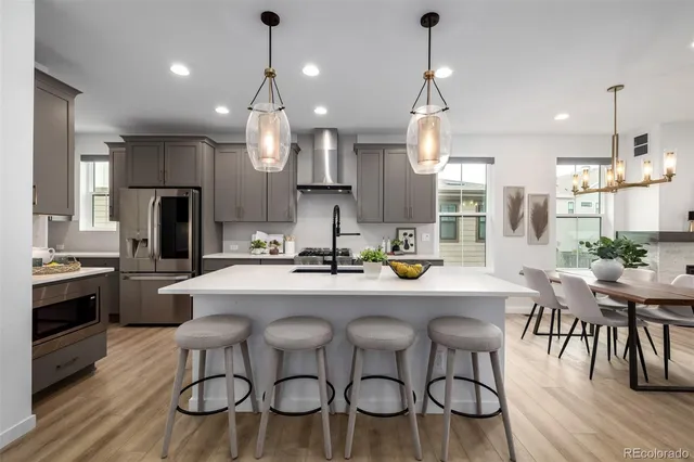 a large kitchen with a table and chairs