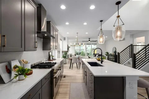a kitchen with counter top space a sink and appliances