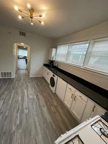 a kitchen that has a stove and a microwave