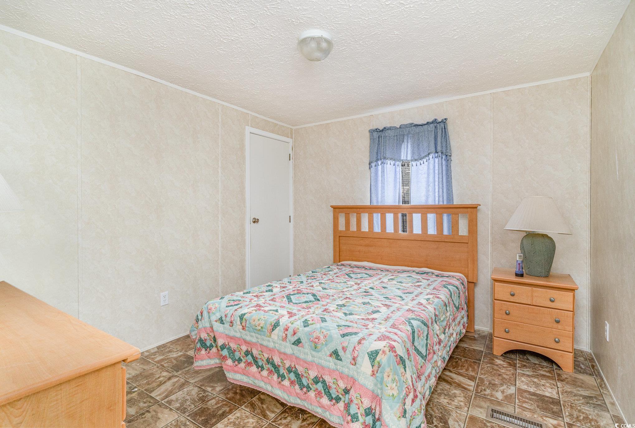 16048 Choppee Road Hemingway, SC 29554 - Photo 21 of 37 Bedroom featuring ornamental molding and a texture