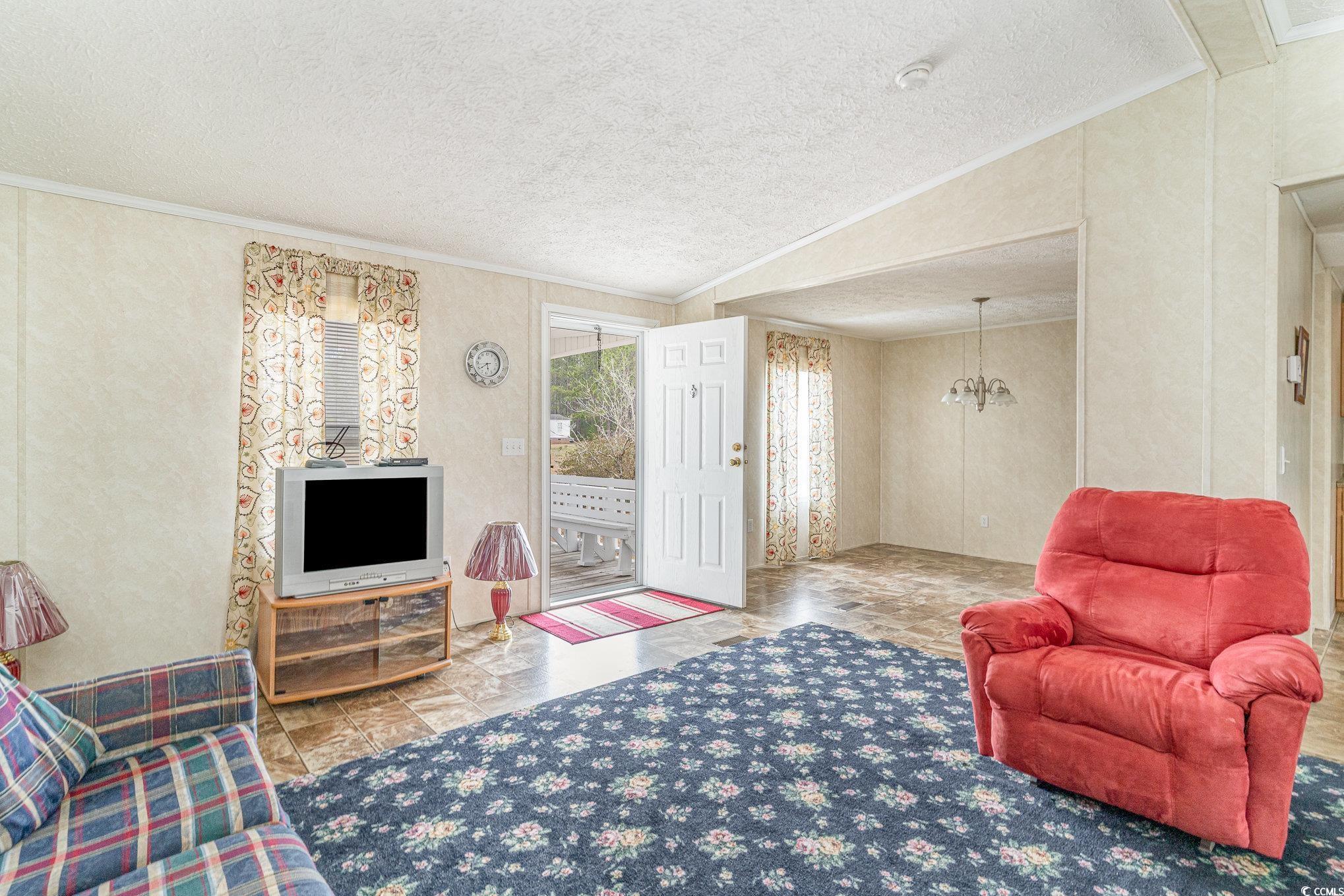 16048 Choppee Road Hemingway, SC 29554 - Photo 5 of 37 Living room featuring lofted ceiling, a notable ch