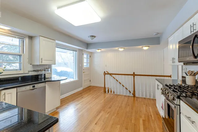 a kitchen with granite countertop stainless steel appliances and cabinets