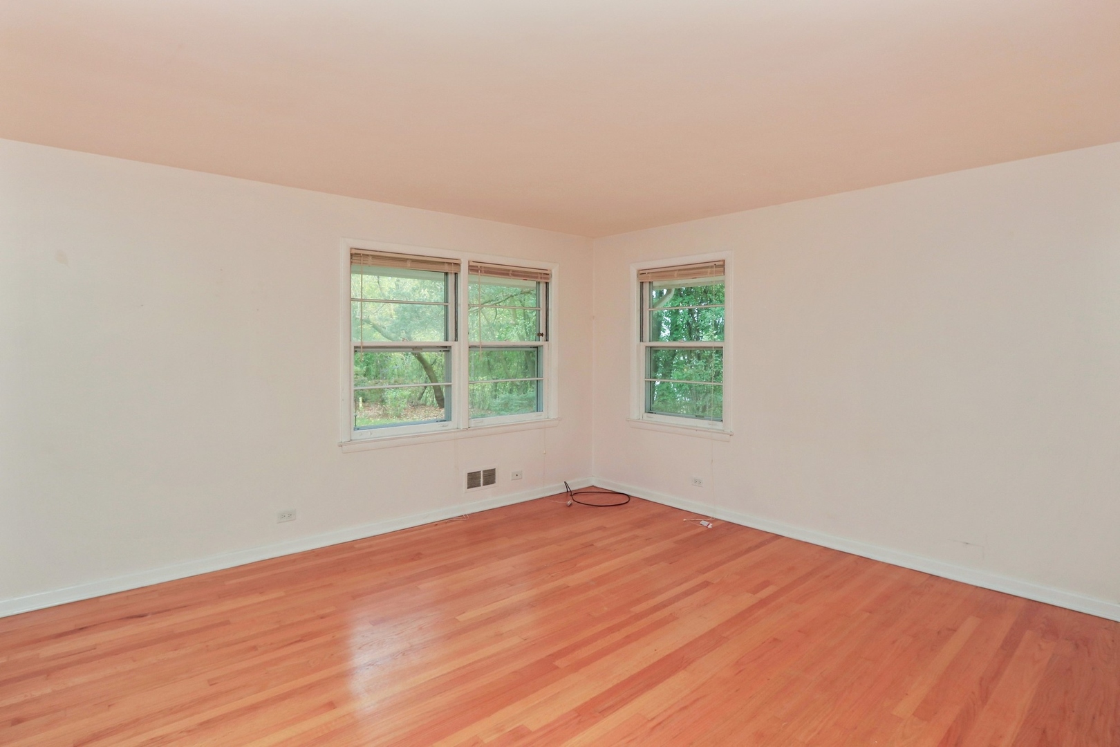 996 Castlegate Court Lake Forest, IL 60045 - Photo 6 of 10 an empty room with wooden floor and windows